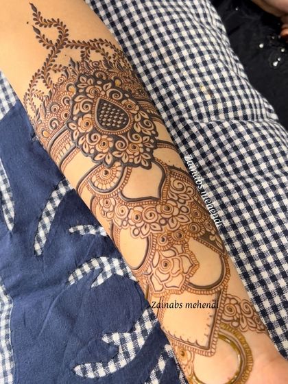 A full forearm design for Ameena, featuring a beautiful mix of paisley, floral, and negative space elements.