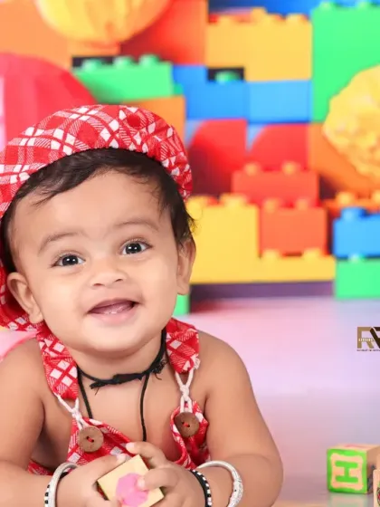 A smiling baby boy plays with a block in the vibrant Lego world. His happy expression shows how much fun these interactive, play-based sessions can be.