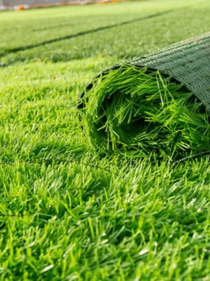 A roll of my 35mm artificial turf ready for installation on a large ground. This type of turf is UV protected and built to cover large areas evenly, making it ideal for lawns or commercial spaces.