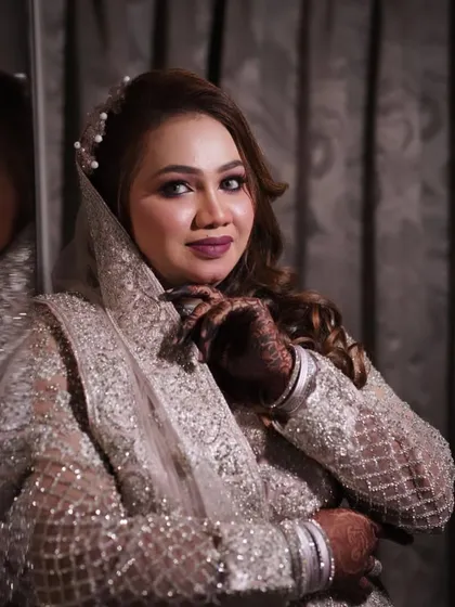 A beautiful portrait of this bride in her silver and pink gown, reflecting in the mirror.