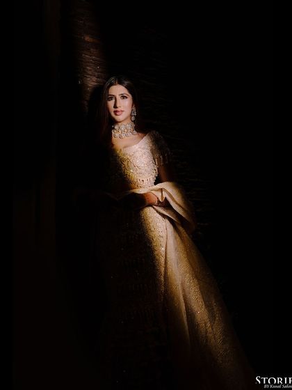 A beautifully lit portrait of the bride, with shadows creating a dramatic and contemplative mood.