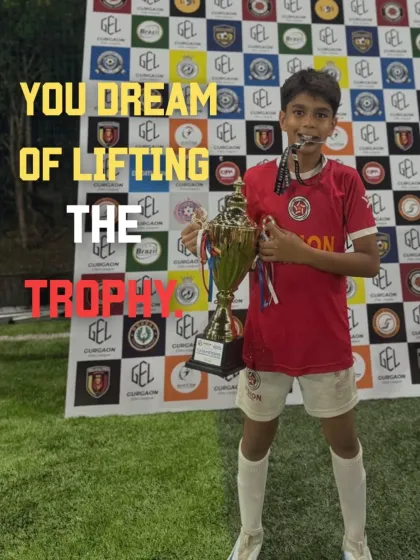 The dream of every young player. Here, one of our champions holds the trophy high, a symbol of dedication and the success that comes from our structured training program.