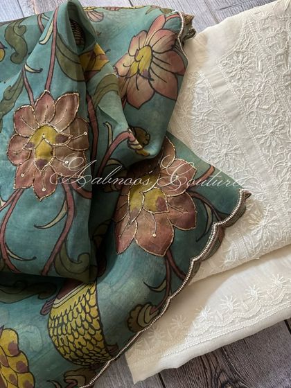 A close-up of the Kalamkari dupatta's scalloped border, which is delicately highlighted with sequins, laid against the intricate white-on-white Chikankari.