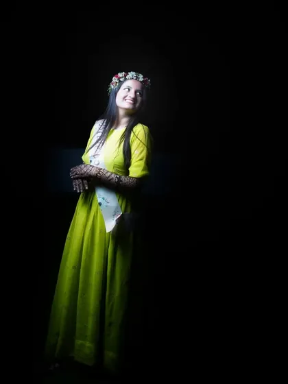 A full-length portrait using creative lighting to make the bride in her yellow dress shine against the dark background. This shows my skill in night and low light photography.
