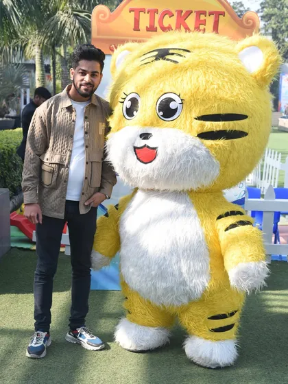 Our mascots are a hit with guests of all ages. Here, an adult guest enjoys a photo opportunity with the cute tiger mascot.