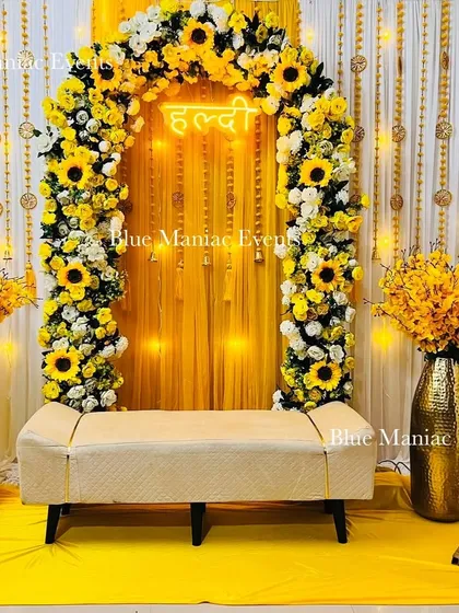 The complete sunflower-themed Haldi setup, with the floral arch, bench seating, golden vases, and quirky props all arranged for the perfect celebration.
