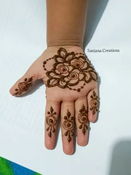 A beautiful floral design for a little one's hands, with simple motifs on the fingers.