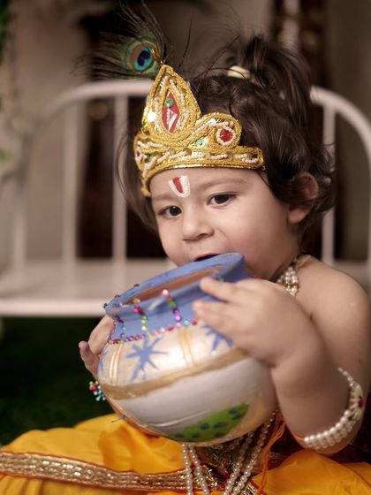 It's all about the candid moments. This little Krishna got a bit mischievous with the butter pot (matki), and I was ready to capture his playful, innocent act.