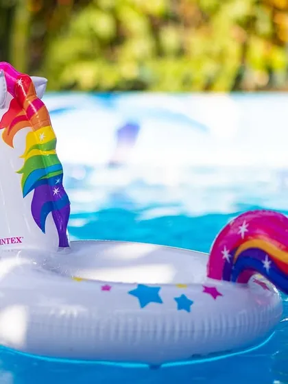 Fun and whimsical pool floats like this unicorn and llama add a touch of magic and are perfect for photos.