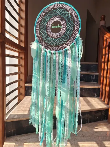 Dreamcatcher magic in Teal Green. Handcrafted with our brand name 'Twinvibes' woven in, this piece is a symbol of protection and positivity, bringing serenity to your space.