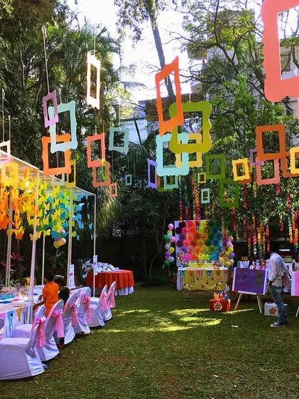 A colorful art-themed birthday party set in a garden. I used hanging frames and a rainbow of colors to inspire creativity and fun for every little artist.