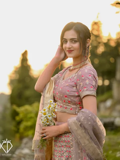 A sweet and gentle portrait of the model holding a bouquet of daisies during the styled shoot.