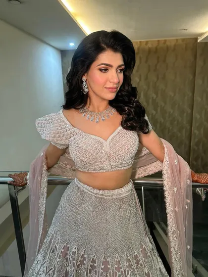 The full look, showing how the soft and pretty makeup complements the pastel lehenga, creating a look of pure elegance.