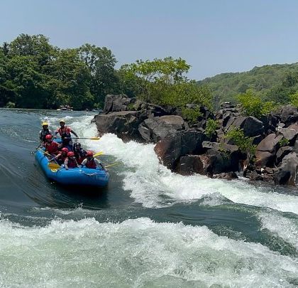 A raft approaches a drop in the river, a moment of anticipation and excitement for the team.
