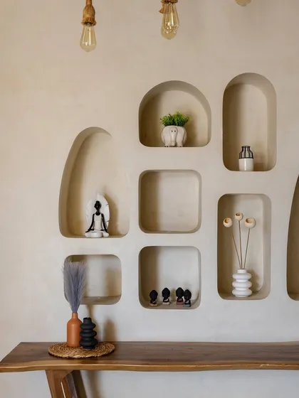 Another view of the organic wall niches, showcasing a collection of accessories from the clients' travels. These personal touches help tell the story of the family that lives here.