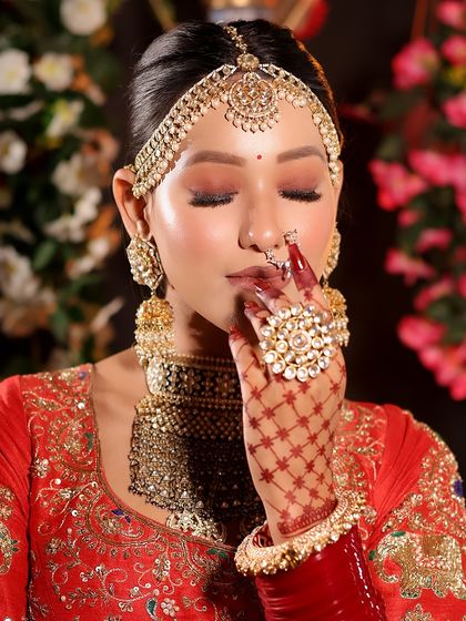 A close-up showcasing the detailed eye makeup and henna. I used warm, shimmery tones on the eyes to complement the bride's jewelry and create a soft, romantic feel.