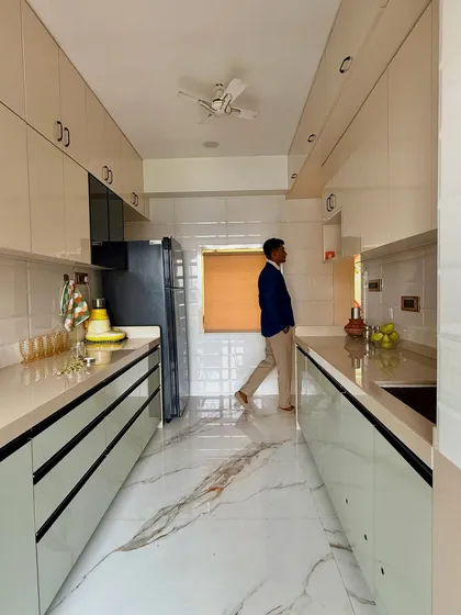 A full view of the galley kitchen, demonstrating its efficient layout. The design ensures everything is within reach, from the stove to the sink to the refrigerator.