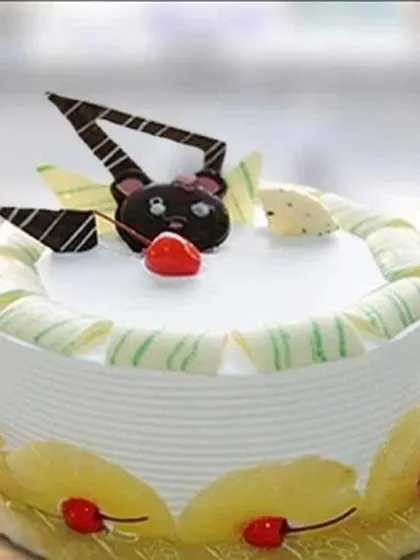 A cute and fun cake for all ages, this design features a chocolate bear face on top of a delicious pineapple cake. It's a great way to add a playful touch to any birthday celebration.