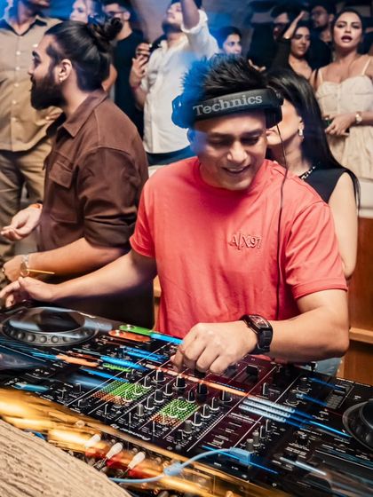 A close-up, high-energy shot of me mixing at Bastian, with a long-exposure effect capturing the lights.