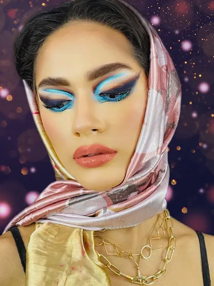 Another perspective of the 1950s inspired look, with eyes closed to showcase the full range of the blue eyeshadow.