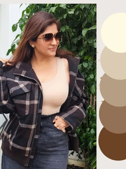 Brown is the color of 2025, and I am showing how to style it with intention. Here, I have paired a plaid brown jacket with a neutral tank and dark jeans. Knowing your undertones is key; warm skin tones glow in caramel and rust, while cool tones suit espresso and taupe.