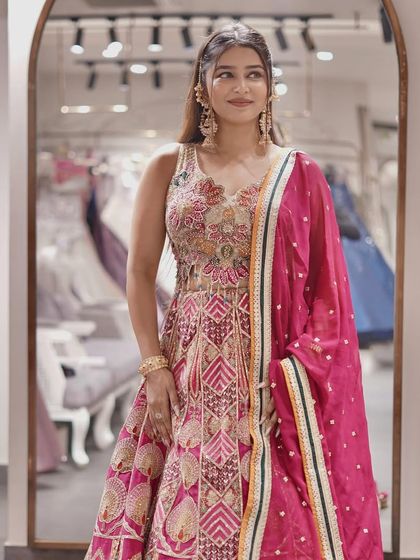 This vibrant pink Anarkali suit is the epitome of feminine charm and elegance.