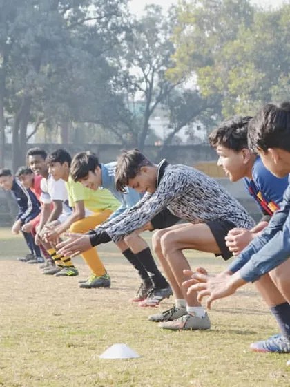 Ready for action. Our young players are lined up and focused during an agility drill, building the speed and explosive power needed on the field. This is the energy we bring to every session.