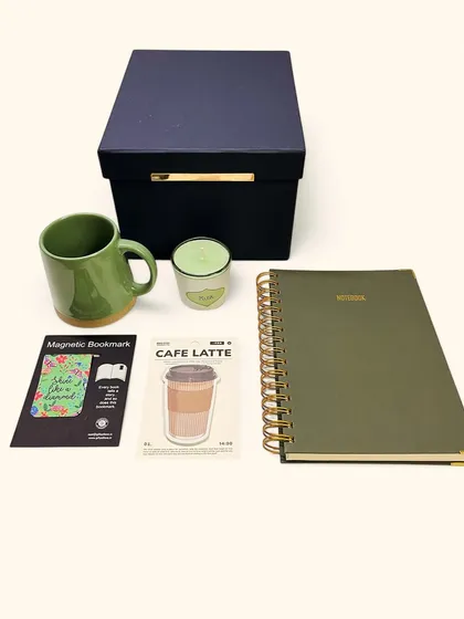 The complete 'Matcha Mornings' set, unboxed. It’s a collection of non-digital antioxidants for your soul, including a notebook, mug, candle, and other small joys to start your day right.