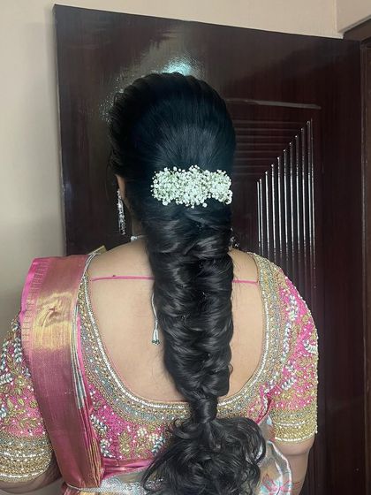 A classic messy braid hairstyle, finished with a bar of delicate baby's breath. This is a versatile look suitable for many different occasions.