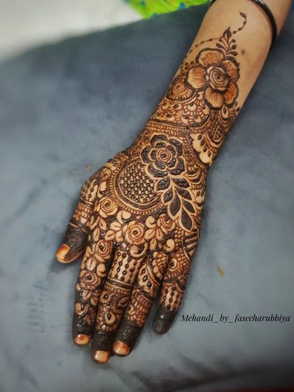 A close-up of the single hand, showcasing the detailed floral and filler work.