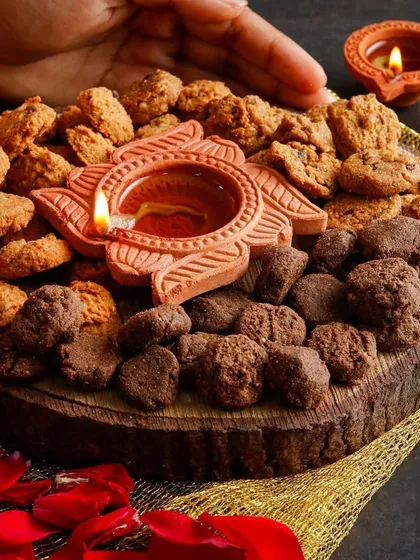 A healthy twist on a Diwali platter, featuring an arrangement of cookies and a central diya for a festive touch.