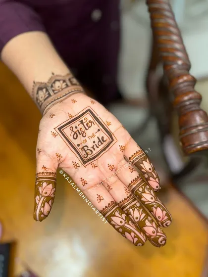 A side view of the 'Sister of the Bride' henna, showing how the minimalist design on the palm is complemented by a delicate wristband pattern.