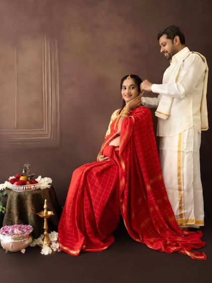A sweet gesture where the husband-to-be lovingly places flowers in his wife's hair during their traditional maternity session.