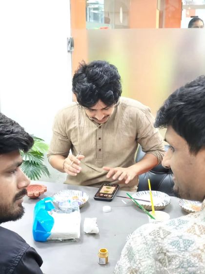 Even in a professional environment, there's room for creativity and fun. Team members here are painting diyas, adding a personal touch to the office's festive decor.