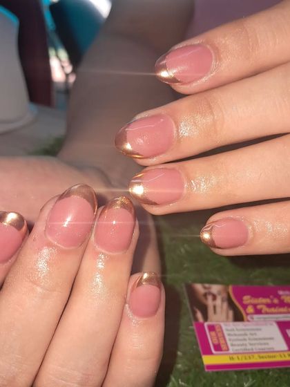 A classic French manicure with a twist. We used a beautiful gold chrome for the tips to create a look that is both timeless and on-trend.