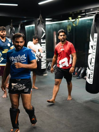 Fighters walk the mat, getting ready for the next drill in a busy class.