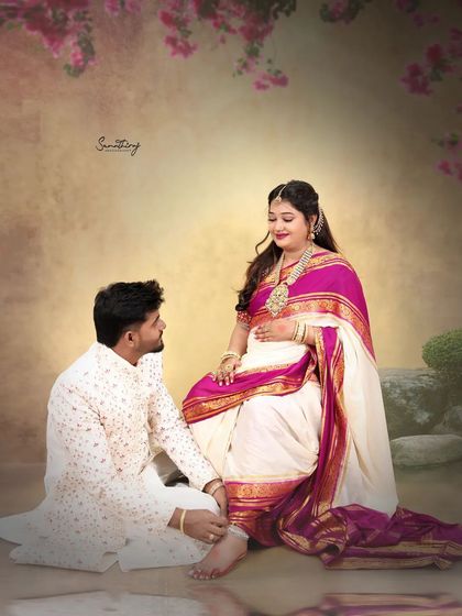 A tender moment captured as a husband-to-be places an anklet on his wife's foot. This beautiful gesture, combined with their traditional attire, creates a deeply symbolic and emotional portrait.
