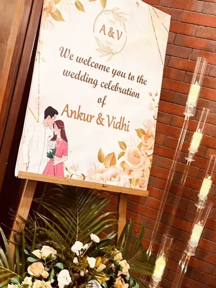 A personalized welcome sign for Ankur and Vidhi's wedding celebration. The sign features a custom illustration of the couple, adding a sweet and personal touch to the entrance decor.