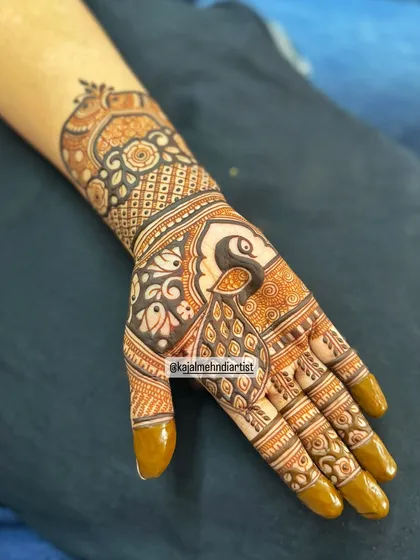 Another example of a quick siders henna design, with a prominent peacock and floral elements.