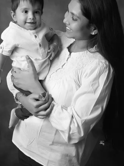 The sweet interaction between a mother and her child is beautifully captured in this black and white image. It feels candid, warm, and full of love.