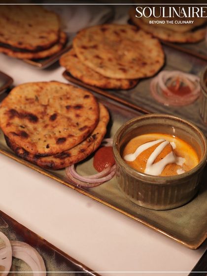 A comforting plate of Dal Makhani served with soft, warm bread. We perfect classic Indian dishes, delivering soulful and authentic flavours.