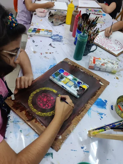 Glimpses from our summer camp, where students explore different techniques like dot painting and abstract art.