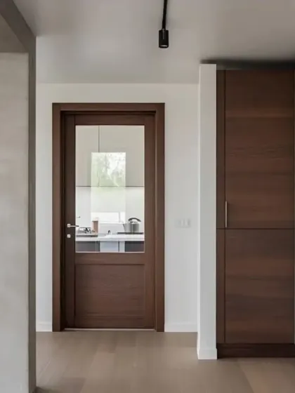 A classic wooden door with a glass panel, adding a touch of elegance to a kitchen entrance.