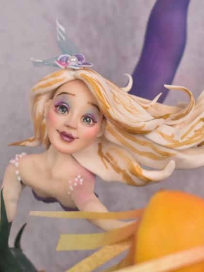 A slightly different close-up of the mermaid's face, highlighting the hand-painted details and the flowing sugar-paste hair.