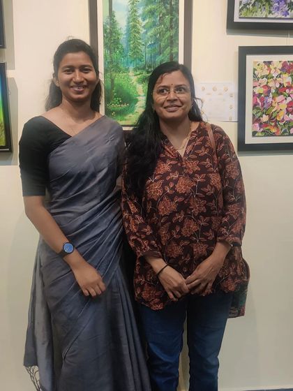 Posing with a friend in front of my 'Golden Path' painting at the CKP art gallery.