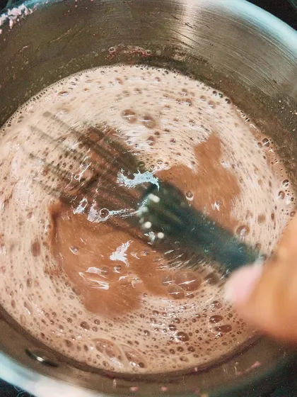 Whisking the pastry cream as it cooks to ensure it's smooth and lump-free. It's a labor of love.