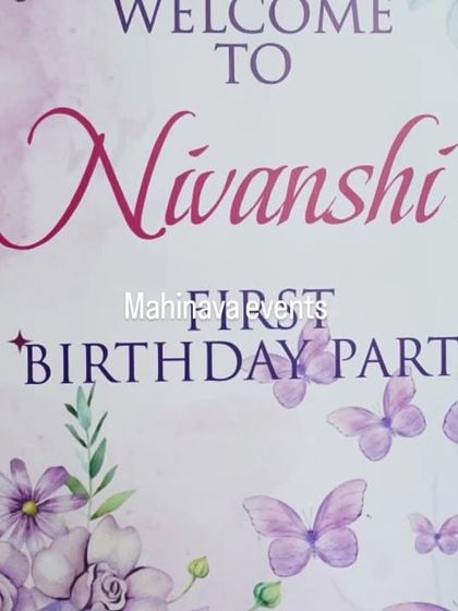 A simple and elegant welcome sign for a first birthday party with a butterfly theme. The watercolor design with purple butterflies and florals sets a gentle and pretty tone for the event.