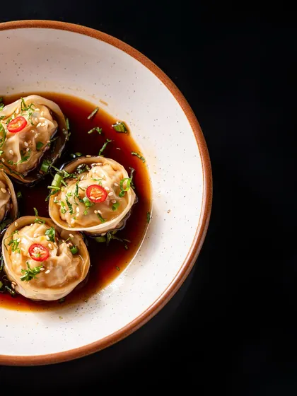 Delicate cottage cheese tortellini dumplings are served in a rich, savoury soy broth and garnished with fresh chillies and herbs. A truly impressive start to any meal.