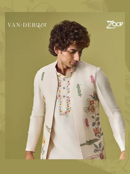 A closer look at the detailed floral embroidery on an off-white Vanderphool jacket. The craftsmanship is evident in every stitch, making it a piece of wearable art.