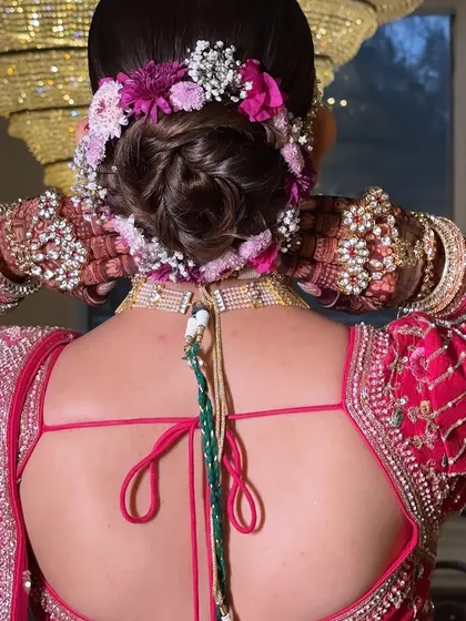 A close-up of Twinkle's beautiful floral bun. The combination of pink and white flowers perfectly matched her stunning pink lehenga.